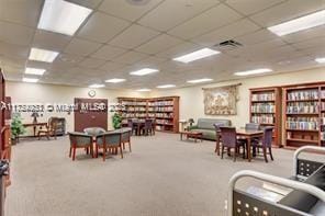 game room with carpet flooring and a drop ceiling