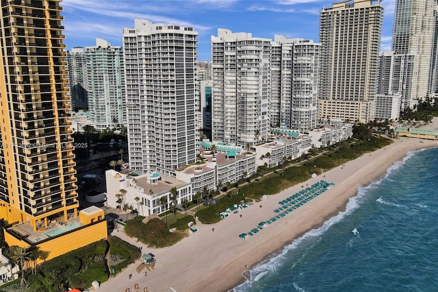 property's view of city with a water view and a beach view