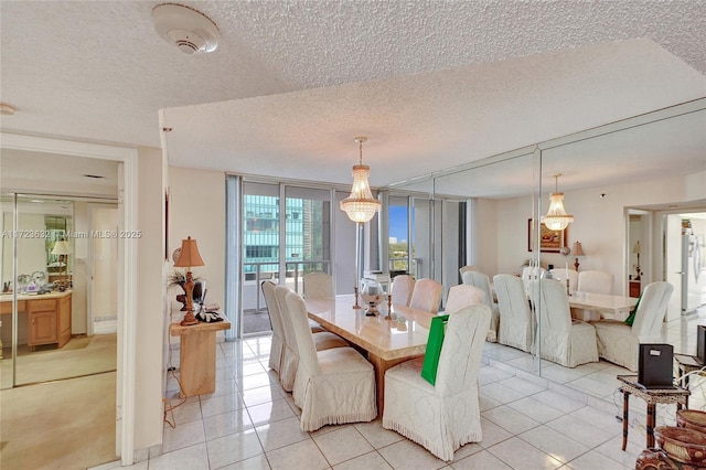 tiled dining space with a textured ceiling and floor to ceiling windows