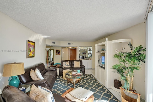 tiled living room with a textured ceiling