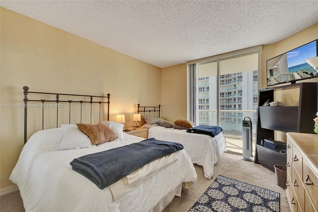 carpeted bedroom featuring a textured ceiling