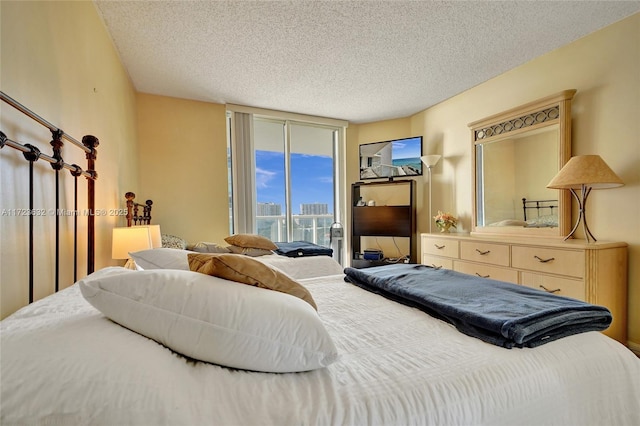 bedroom with access to exterior and a textured ceiling