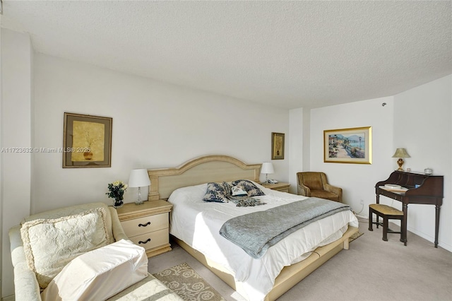 bedroom featuring light carpet and a textured ceiling