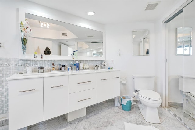 bathroom with decorative backsplash, a shower, toilet, and vanity