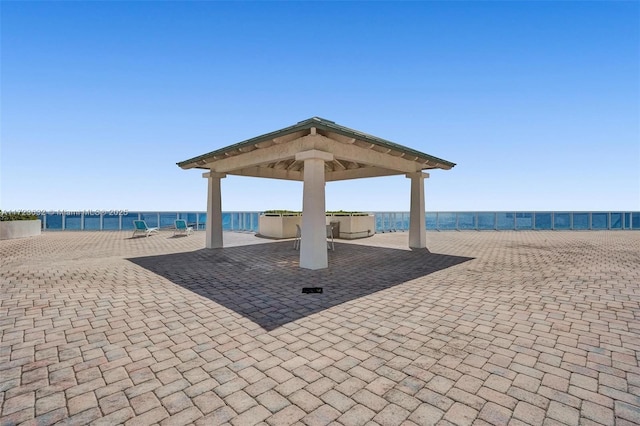 view of patio / terrace with a water view and a gazebo