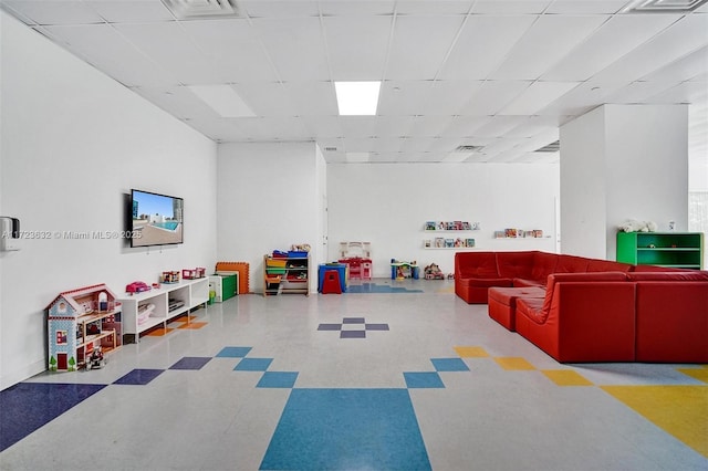 recreation room featuring a paneled ceiling