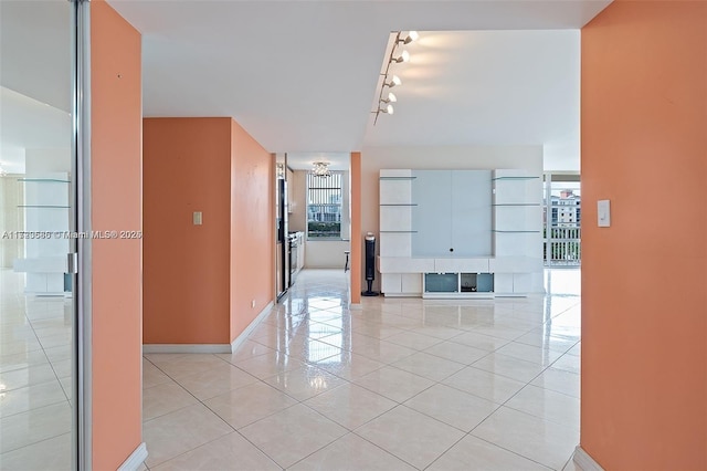 hall with light tile patterned floors