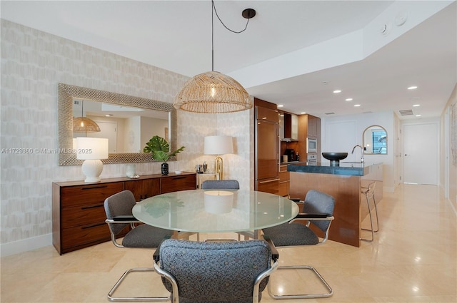 dining space with light tile patterned floors and sink