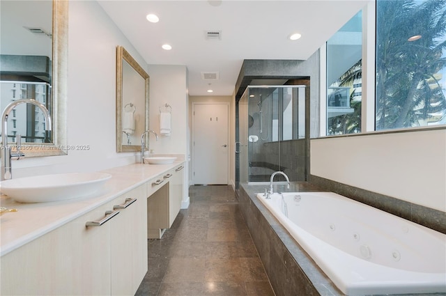 bathroom featuring vanity and separate shower and tub