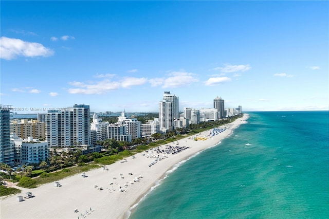 birds eye view of property with a view of the beach and a water view