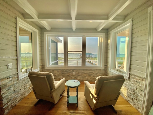 living area featuring crown molding, beamed ceiling, wood finished floors, and coffered ceiling