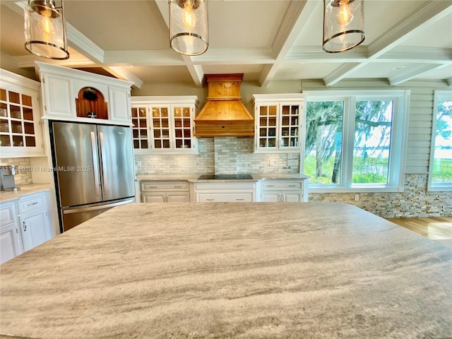 424 Lake Mirror Dr, Lake Placid, FL 33852 - kitchen featuring freestanding refrigerator, coffered ceiling, custom range hood, glass insert cabinets, and white cabinets