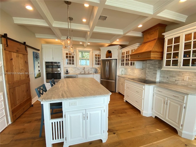 424 Lake Mirror Dr, Lake Placid, FL 33852 - kitchen with appliances with stainless steel finishes, a sink, a barn door, a center island, and beam ceiling