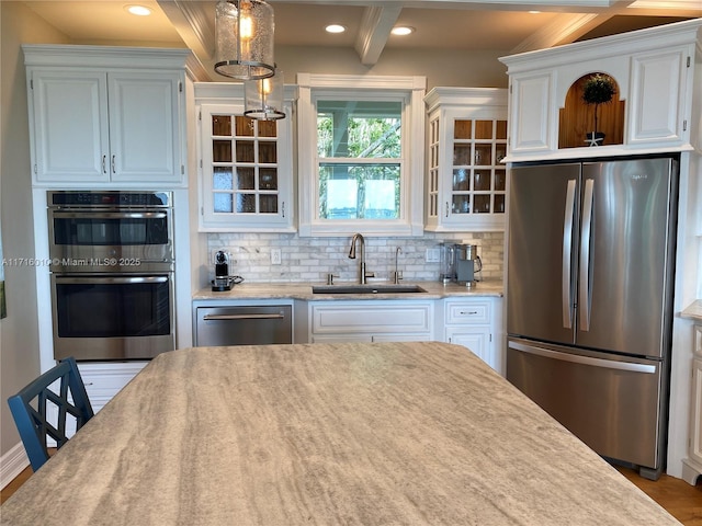 424 Lake Mirror Dr, Lake Placid, FL 33852 - kitchen with stainless steel appliances, a sink, decorative backsplash, white cabinets, and light countertops
