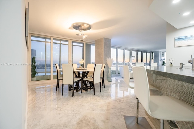 dining area featuring floor to ceiling windows