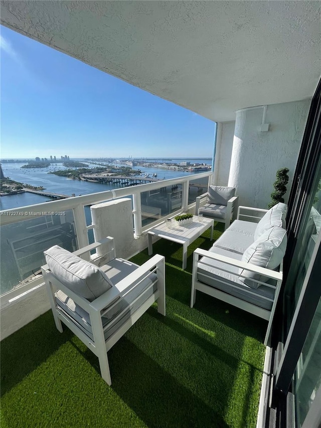 balcony featuring an outdoor hangout area and a water view