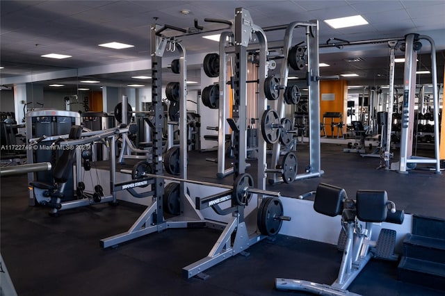 gym with a paneled ceiling