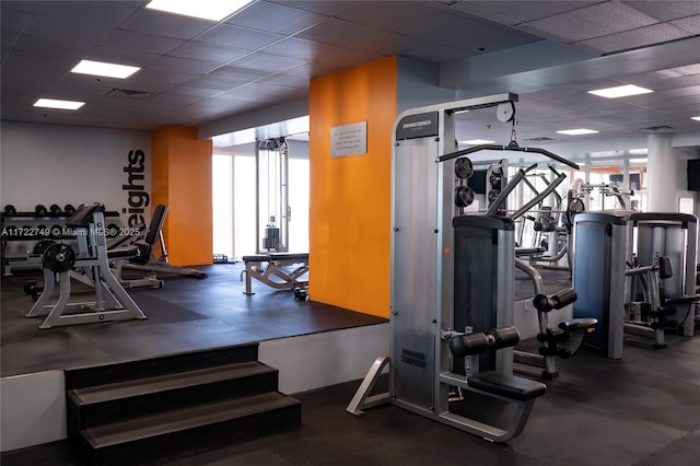 workout area with a paneled ceiling