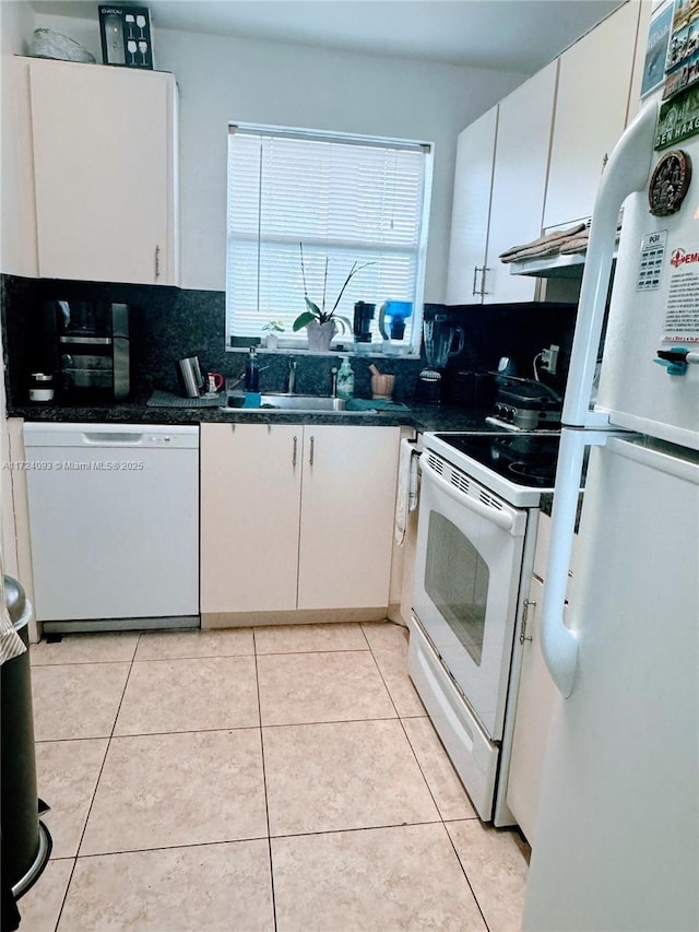 kitchen featuring white cabinetry, sink, white appliances, decorative backsplash, and light tile patterned floors