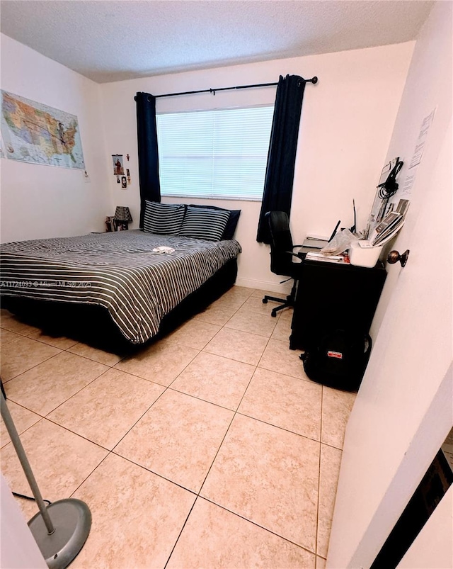 tiled bedroom with a textured ceiling