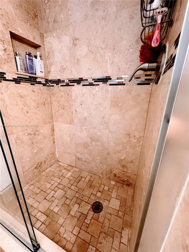 bathroom with tiled shower