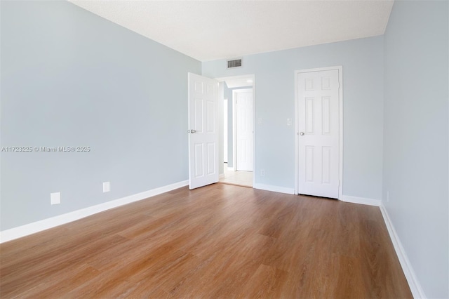 spare room featuring hardwood / wood-style floors