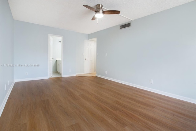 spare room with a textured ceiling, hardwood / wood-style flooring, and ceiling fan