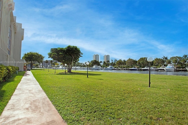 view of community with a water view and a yard