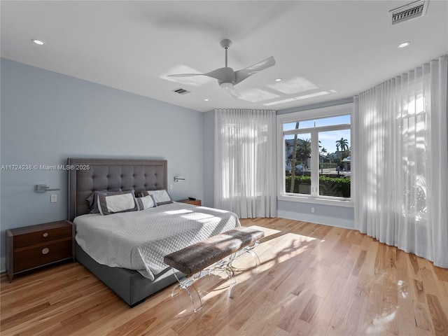 bedroom with ceiling fan and light hardwood / wood-style flooring