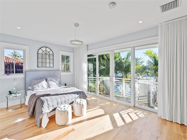 bedroom with light hardwood / wood-style floors and access to exterior