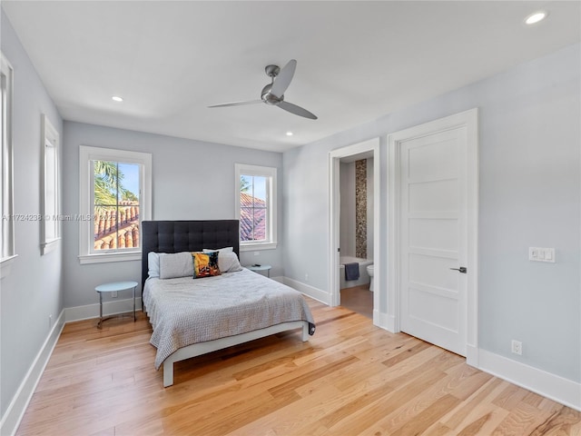 bedroom with ceiling fan, ensuite bath, and light wood-type flooring