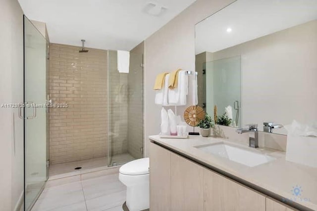 bathroom featuring tile patterned flooring, vanity, toilet, and a shower with door