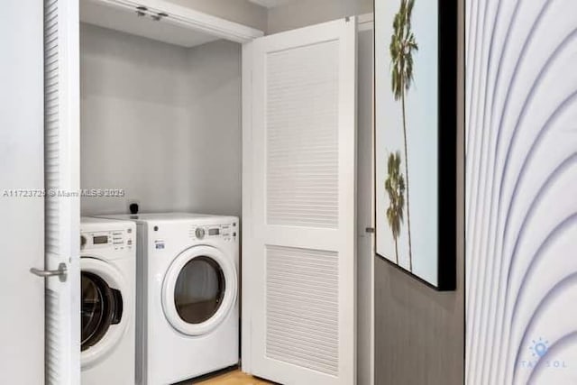 washroom with washing machine and clothes dryer