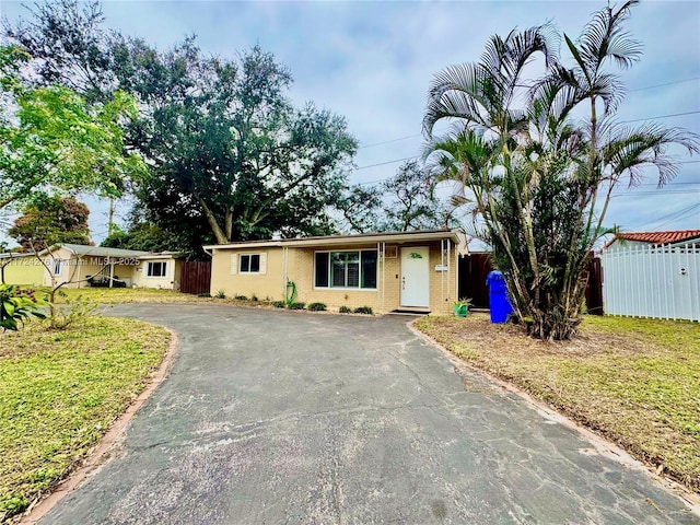 single story home featuring a front lawn