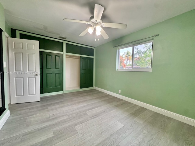 unfurnished bedroom featuring ceiling fan, light hardwood / wood-style flooring, and a closet