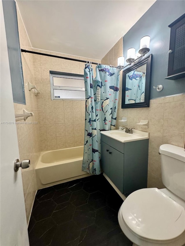 full bathroom featuring tile patterned floors, vanity, shower / bathtub combination with curtain, tile walls, and toilet