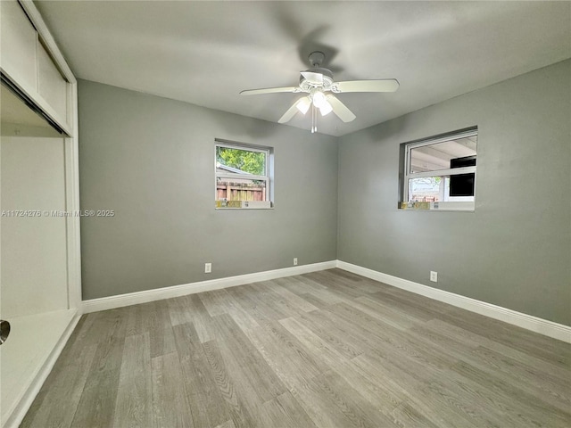 unfurnished bedroom with ceiling fan, a closet, and light wood-type flooring