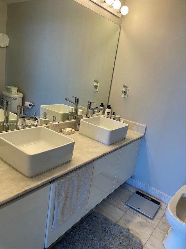 bathroom with tile patterned floors, vanity, and toilet