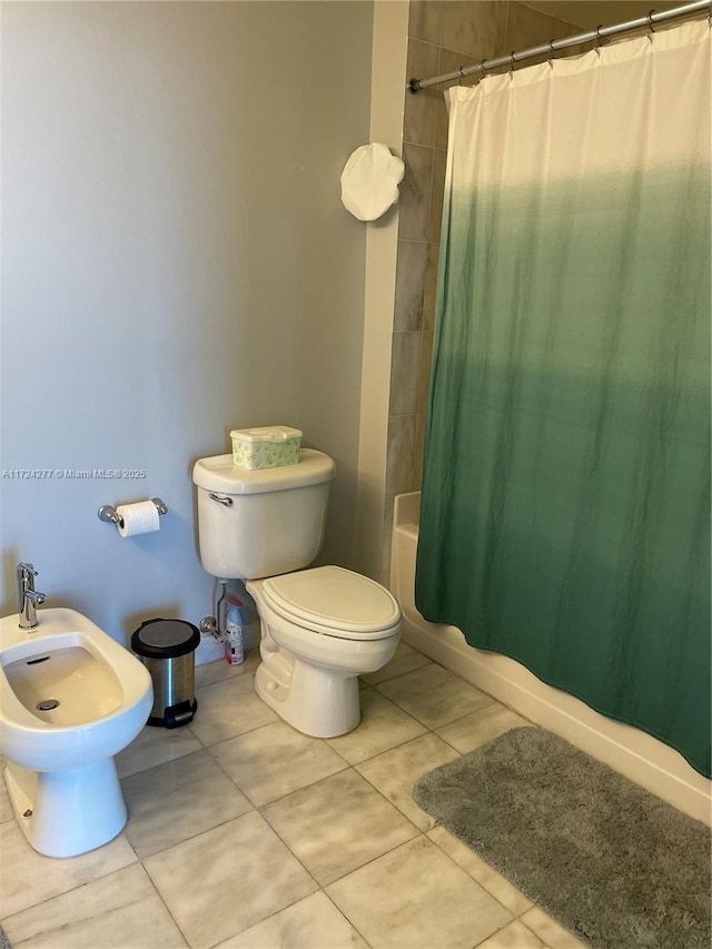 bathroom with tile patterned floors, toilet, shower / bathtub combination with curtain, and a bidet