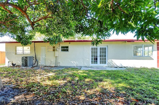 back of house with central AC unit