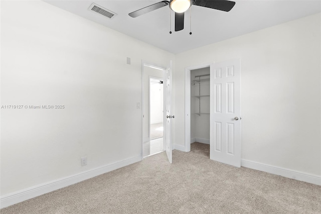 unfurnished bedroom featuring light carpet, a closet, and ceiling fan