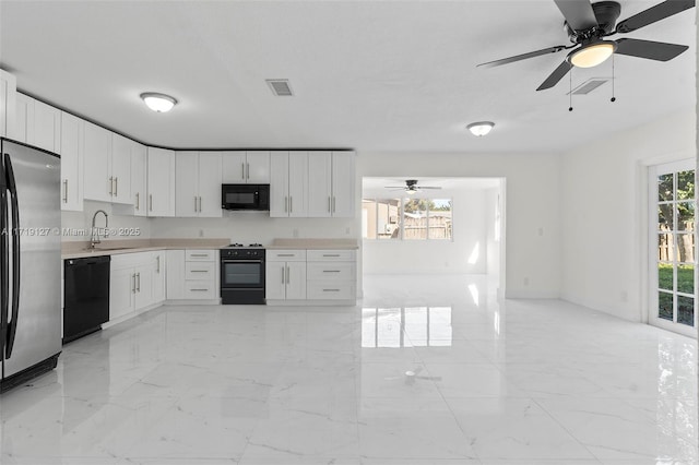 kitchen featuring black appliances, ceiling fan, white cabinetry, and sink