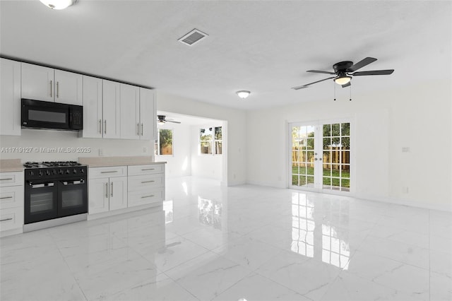 kitchen with white cabinets, french doors, and black appliances