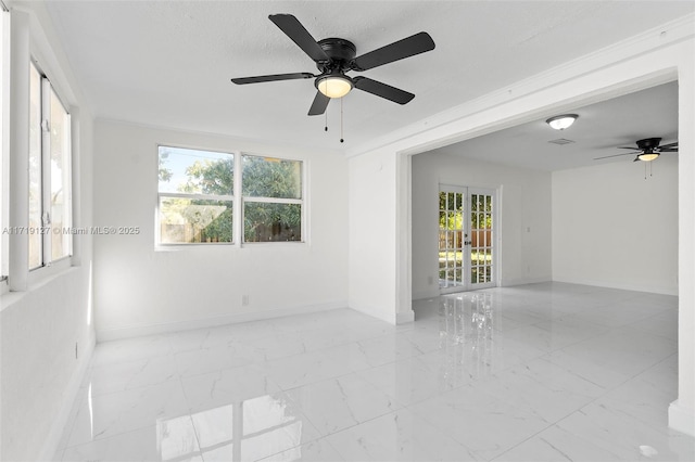 empty room with ceiling fan and crown molding