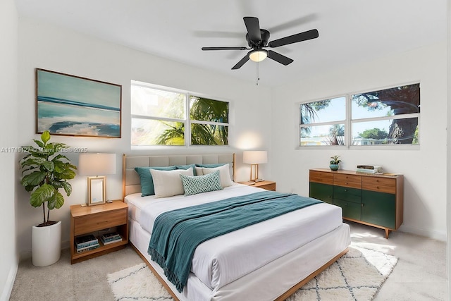 bedroom featuring ceiling fan and light colored carpet