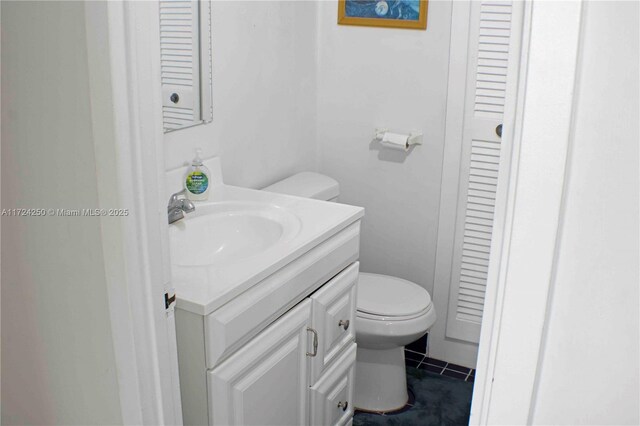 bathroom with tile patterned floors, vanity, and toilet