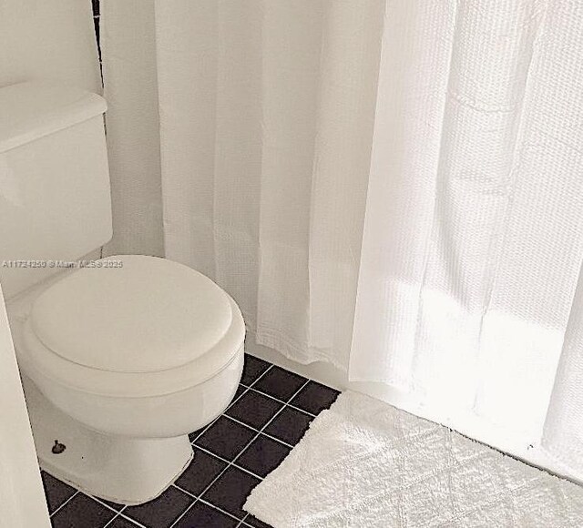 bathroom featuring tile patterned floors and toilet