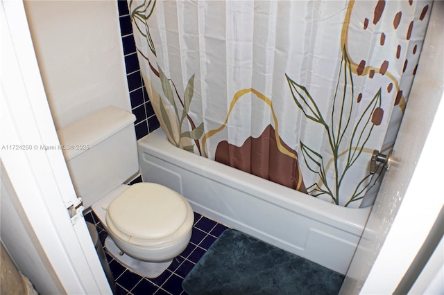 bathroom with toilet, tile patterned flooring, and shower / tub combo