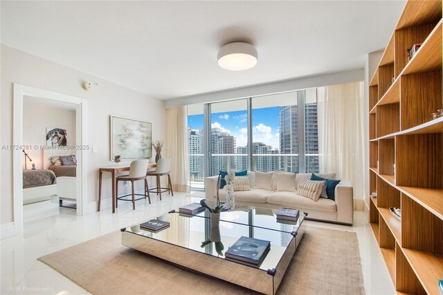 living room featuring light tile patterned floors and floor to ceiling windows