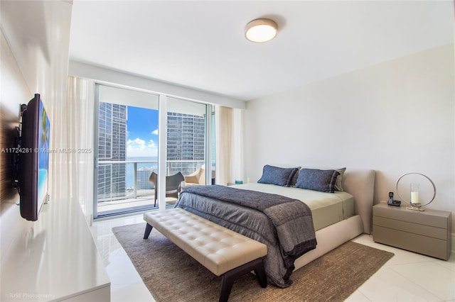 tiled bedroom with expansive windows and access to outside